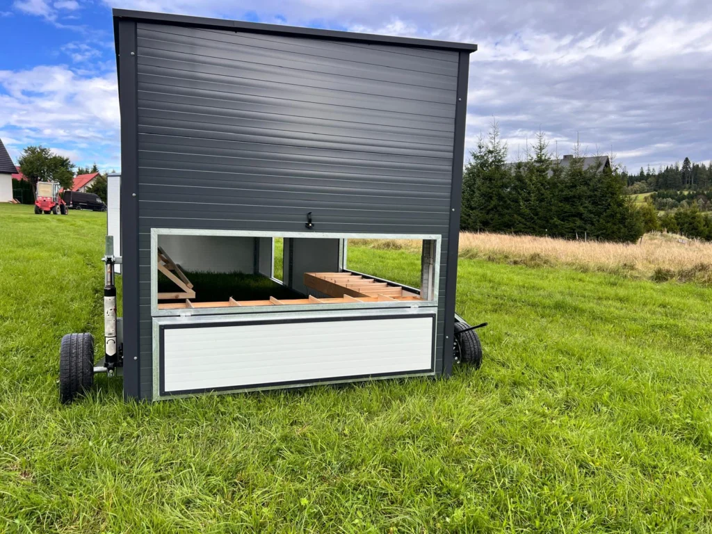 specjalne okno do łatwiejszego zbierania jaj w dużym mobilnym kurniku